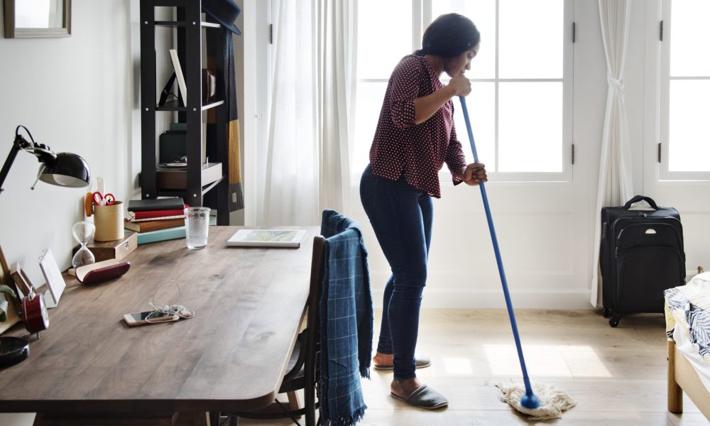 Black woman cleaning room